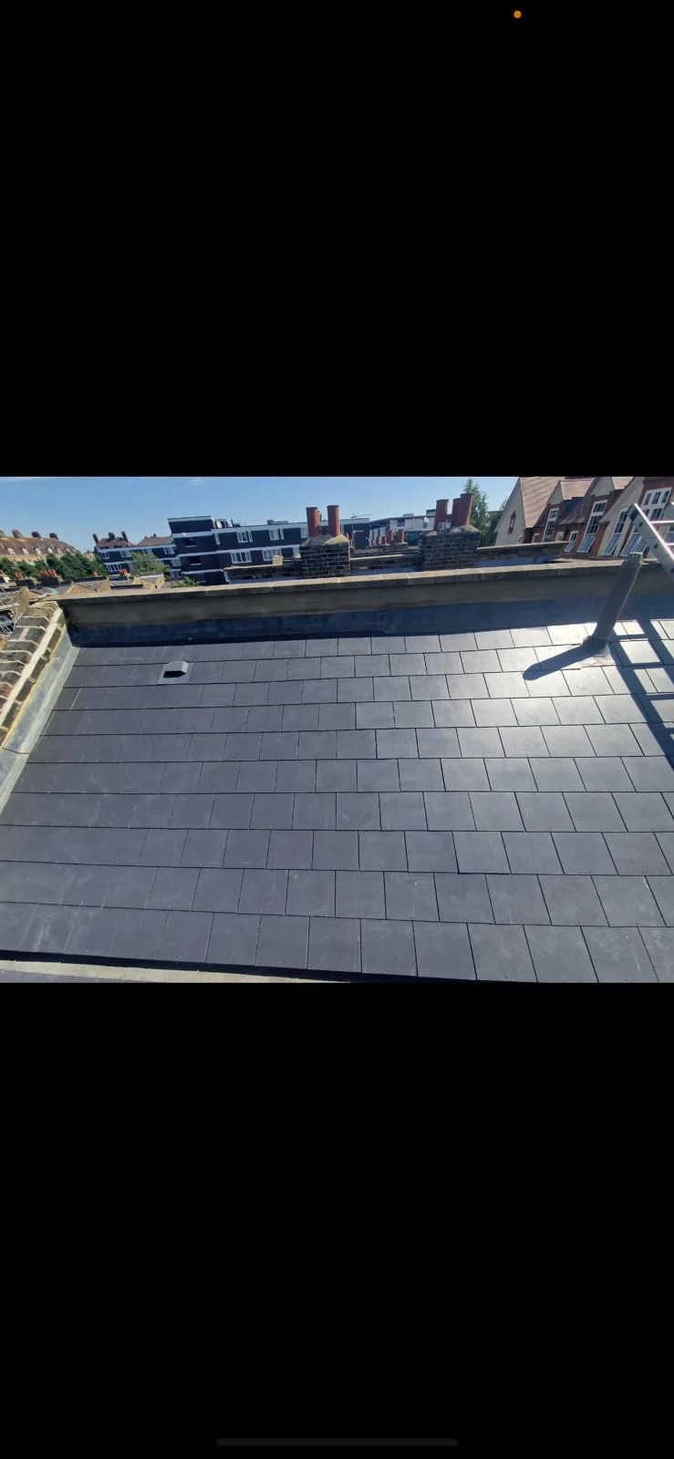 Finished flat slate roofing project photographed from above